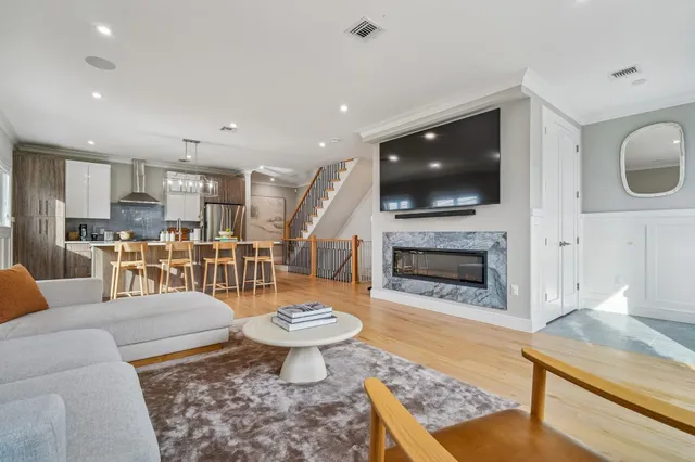 a living room with furniture kitchen view and a dining table