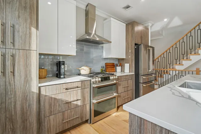 a bathroom with a toilet sink vanity and mirror