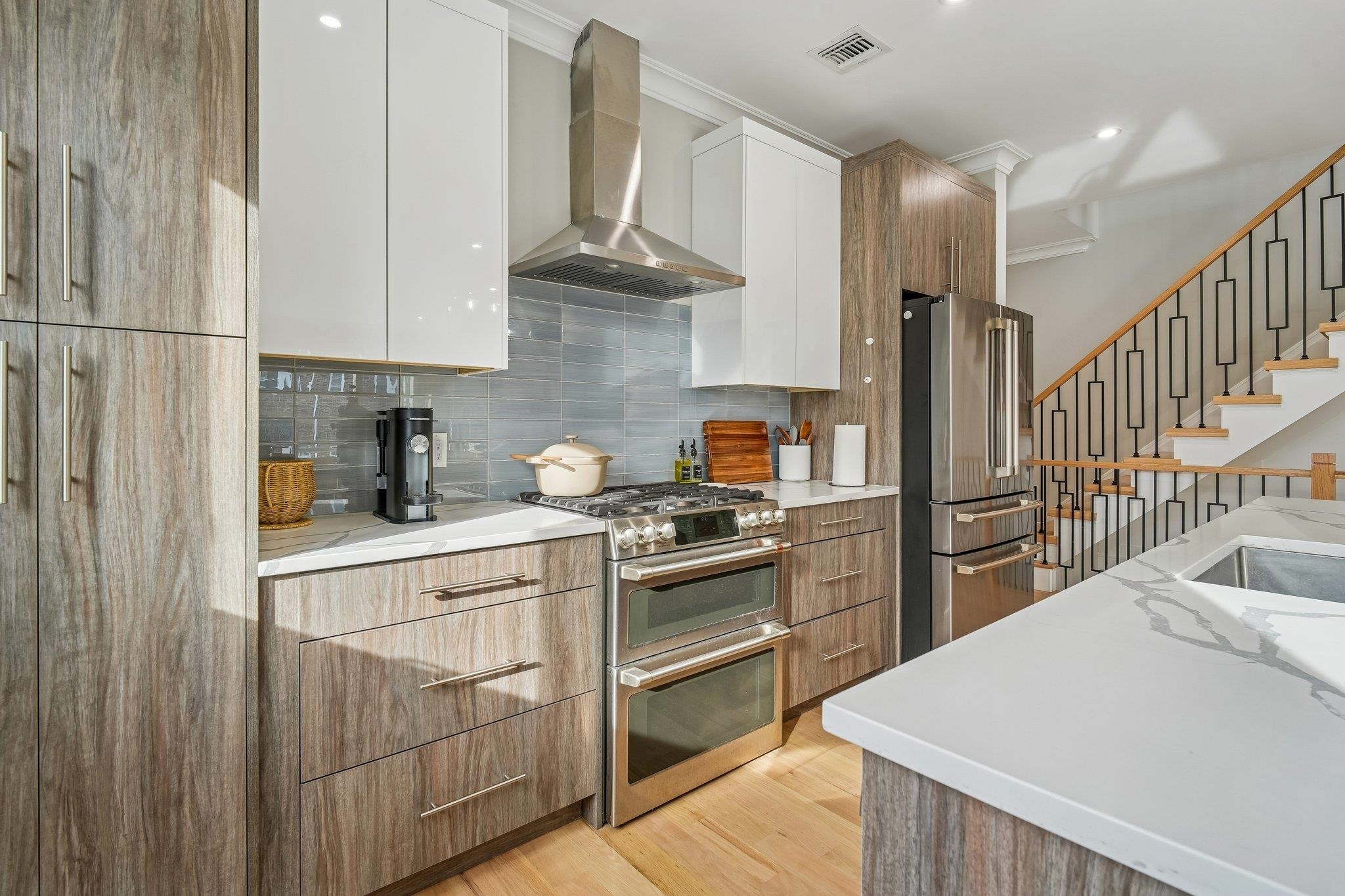 305 8th Street Fairview, NJ 07022 - Photo 10 of 27 a kitchen with cabinets and stainless steel appliances