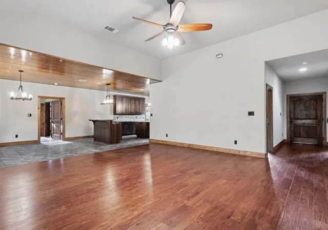 a view of kitchen and hall with wooden floor