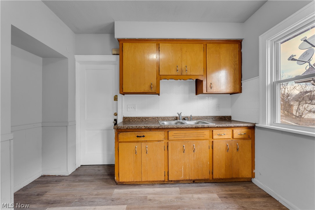860 Greyton Road Cleveland Heights, OH 44112 - Photo 21 of 31 Kitchen featuring sink, tasteful backsplash, and hardwood / wood-style floors