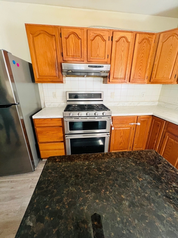 524 Merrimack Street Methuen, MA 01844 - Photo 14 of 34 a view of kitchen and wooden floor