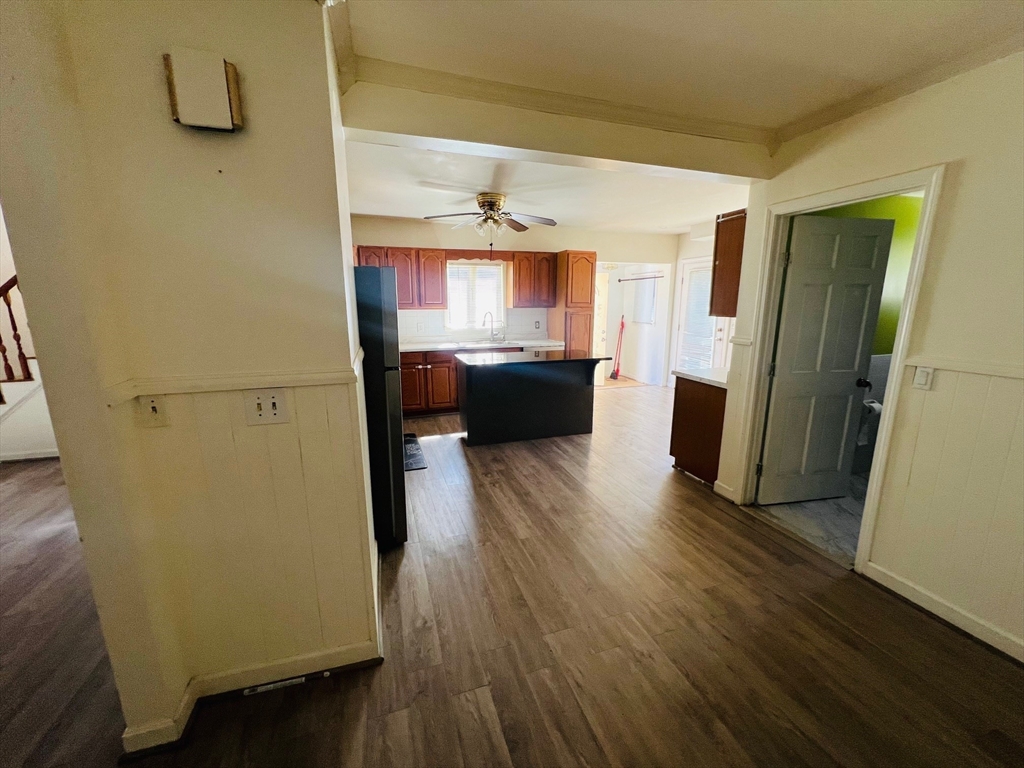 524 Merrimack Street Methuen, MA 01844 - Photo 16 of 34 a view of a hallway with wooden floor and furniture