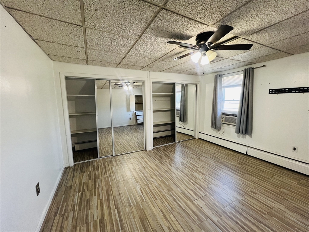 524 Merrimack Street Methuen, MA 01844 - Photo 18 of 34 a view of empty room with wooden floor and windows