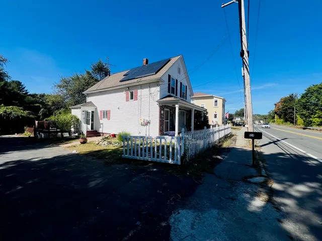 a view of a house with backyard and sitting area