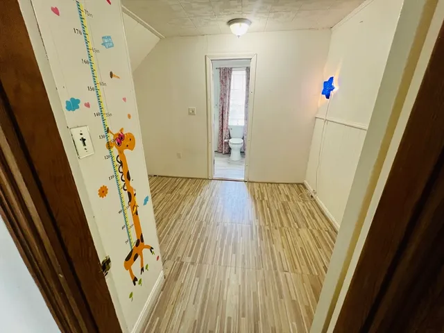 a view of front door with wooden floor