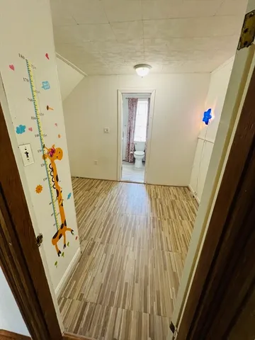 a view of an entryway with wooden floor
