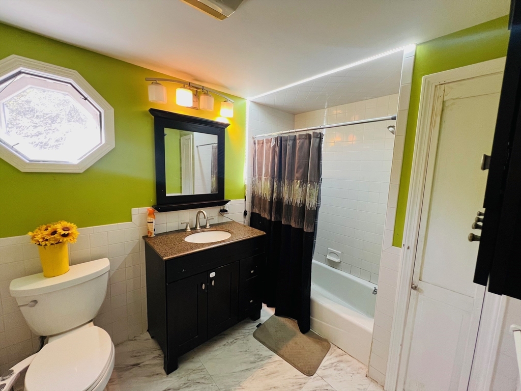 524 Merrimack Street Methuen, MA 01844 - Photo 25 of 34 a bathroom with a toilet sink and mirror