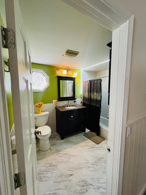 524 Merrimack Street Methuen, MA 01844 - Photo 26 of 34 a bathroom with a sink a toilet and a large mirror