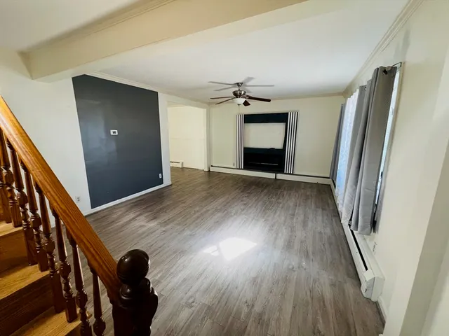 wooden floor in an empty room with a fireplace