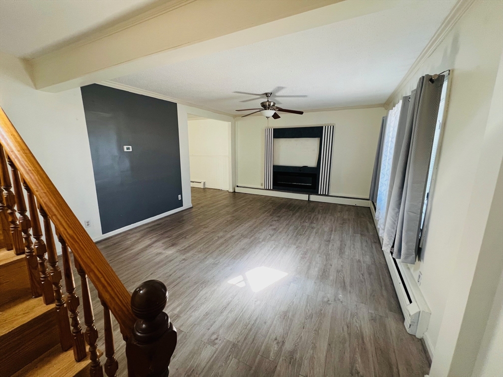 524 Merrimack Street Methuen, MA 01844 - Photo 29 of 34 wooden floor in an empty room with a fireplace