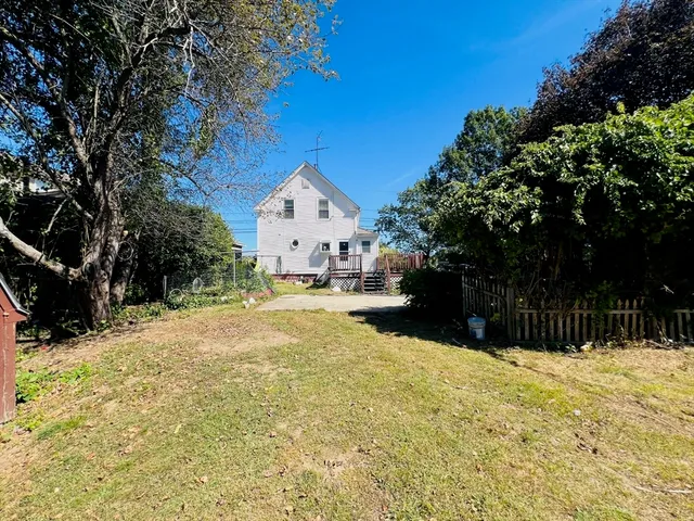 a view of a house with a yard covered with snow in front of house