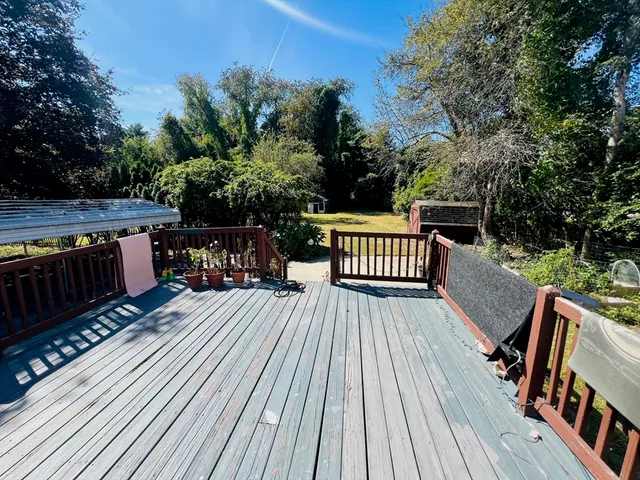 a view of balcony with wooden floor and outdoor seating
