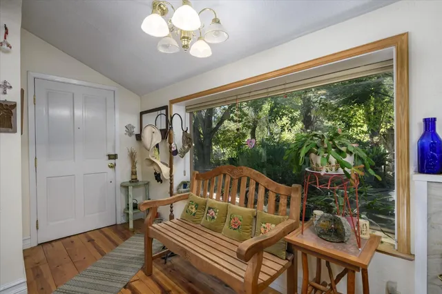 a living room with furniture kitchen view and a large window