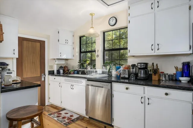a view of a workspace with furniture and a bookshelf