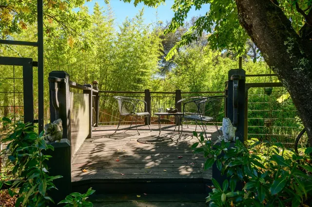 a view of backyard with seating area and green space