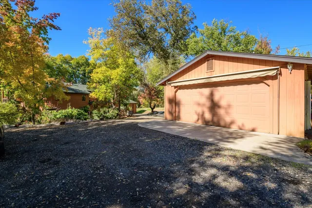 an aerial view of a houses with a lush green hillside