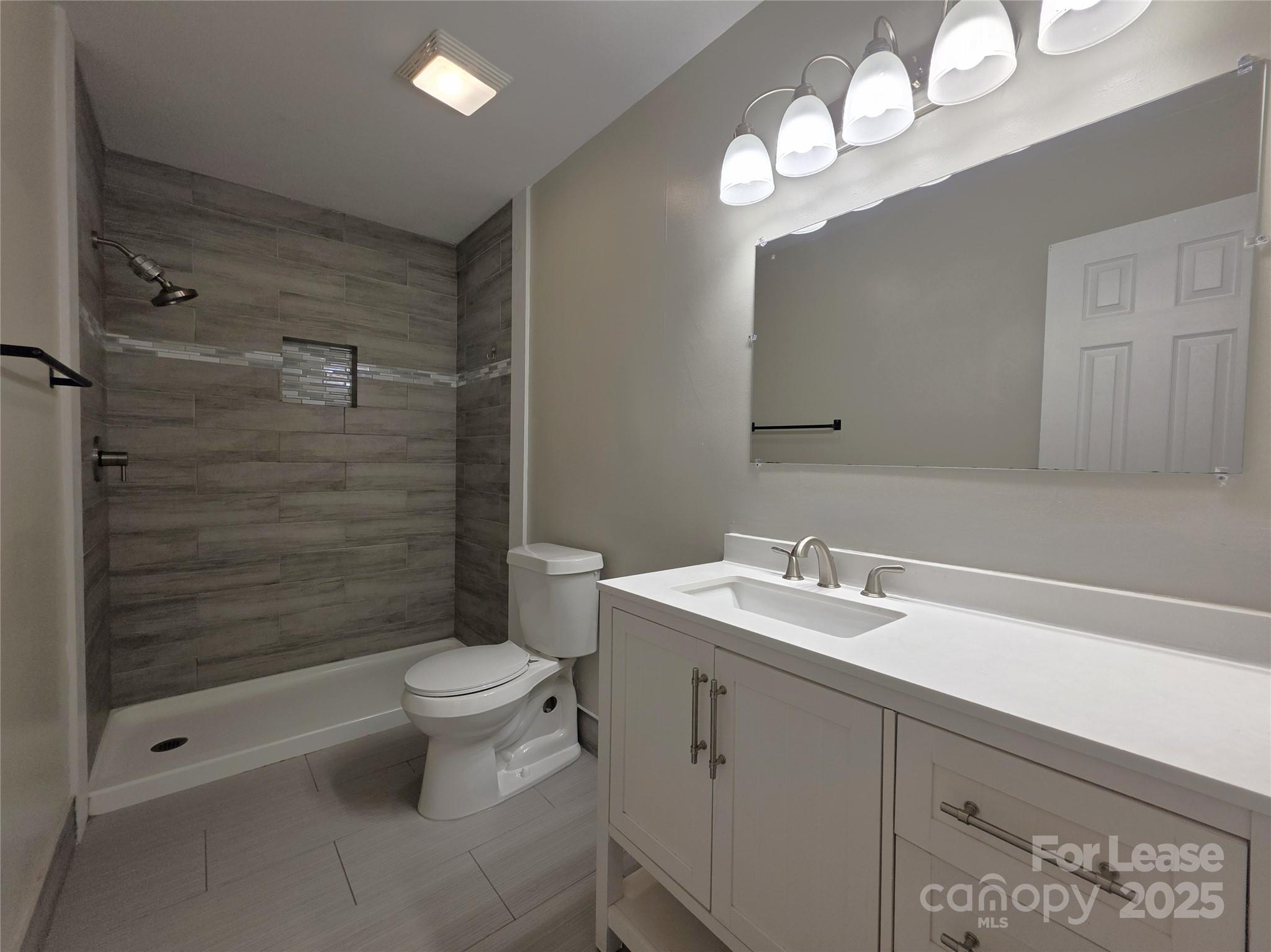 403 Spring Street Northwest Concord, NC 28025 - Photo 13 of 17 a bathroom with a sink a toilet and shower