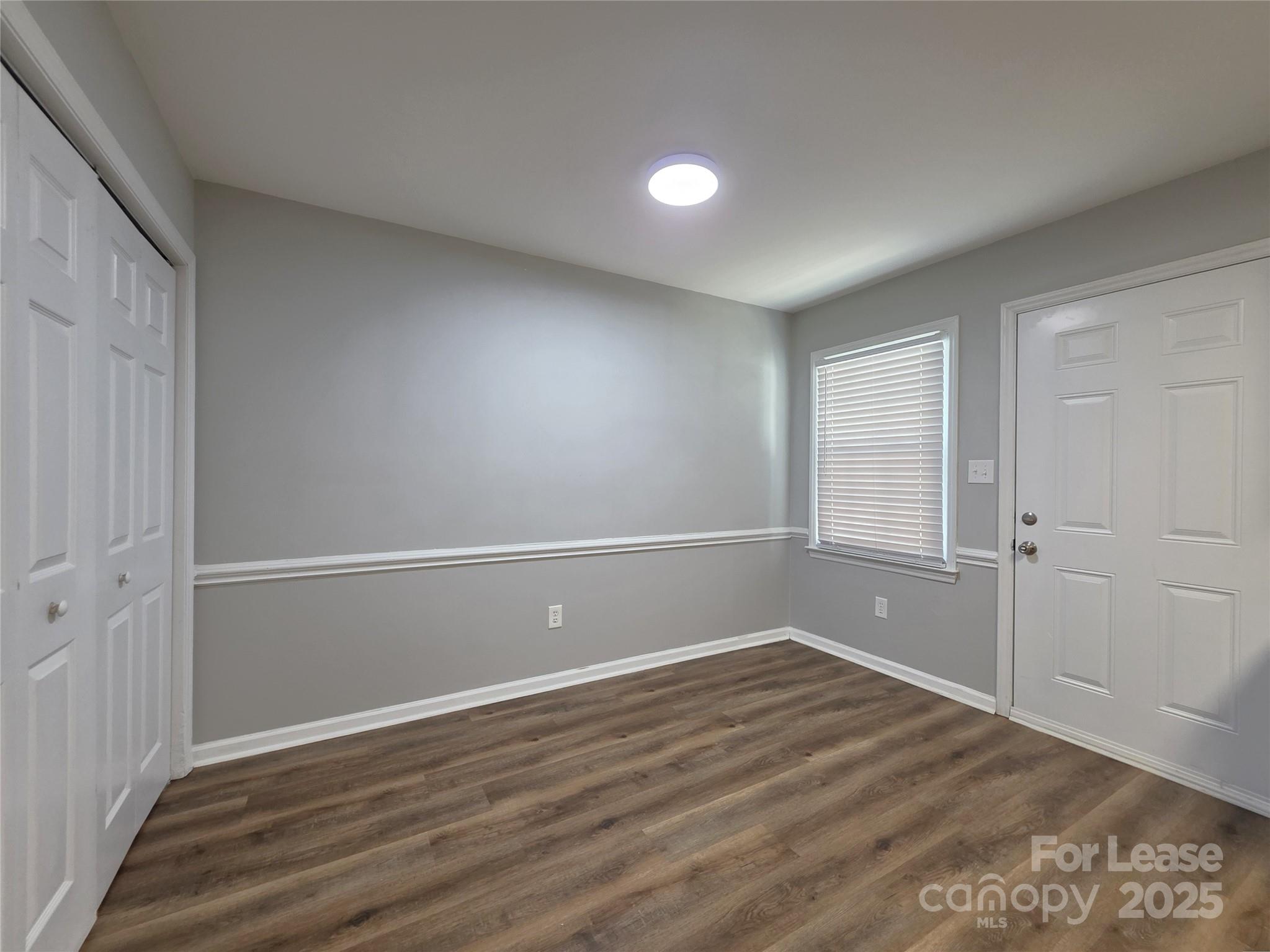 403 Spring Street Northwest Concord, NC 28025 - Photo 5 of 17 a view of empty room with wooden floor