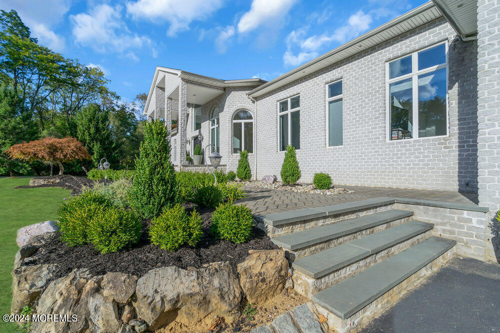 27 Revolutionary Road Colts Neck, NJ 07722 - Photo 3 of 77 a front view of a house with a garden