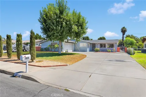 a view of a house with palm trees
