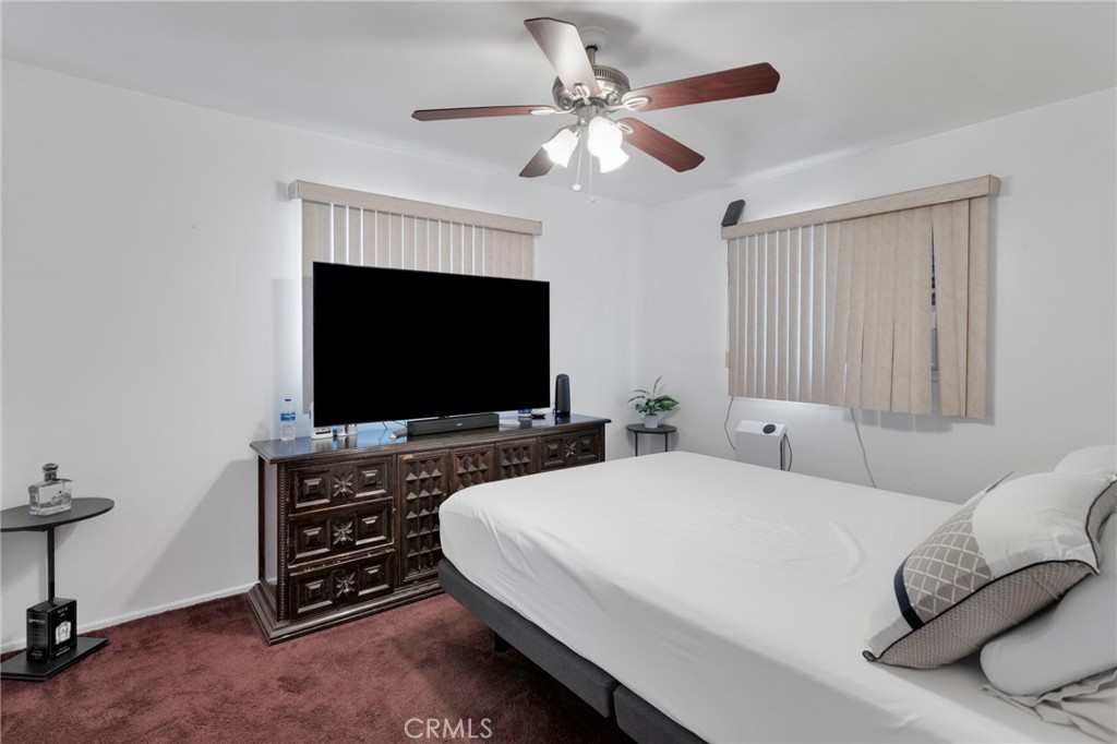 7925 Spohn Avenue Fontana, CA 92336 - Photo 12 of 25 a bedroom with a bed and a flat screen tv