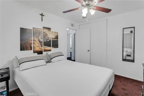 a bedroom with a large bed and a chandelier