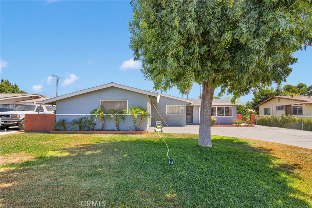 7925 Spohn Avenue Fontana, CA 92336 - Photo 2 of 25 a view of a house with a yard and a large tree
