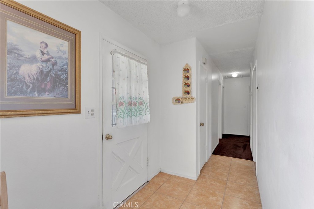 7925 Spohn Avenue Fontana, CA 92336 - Photo 4 of 25 a view of a hallway with wooden floor