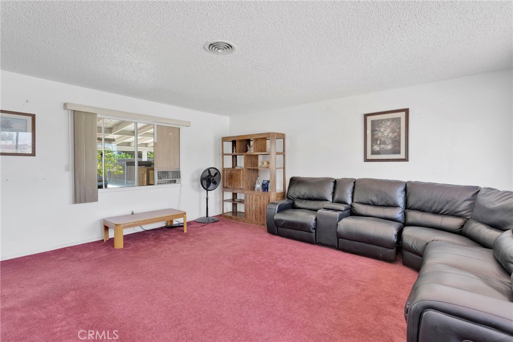 7925 Spohn Avenue Fontana, CA 92336 - Photo 7 of 25 a living room with furniture window and wooden floor