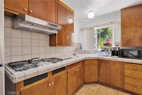 a kitchen with a sink stove and cabinets