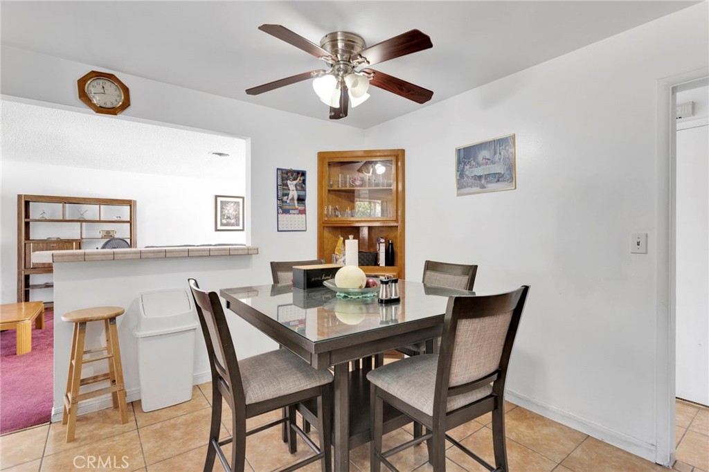 7925 Spohn Avenue Fontana, CA 92336 - Photo 10 of 25 a view of a dining room with furniture and a chandelier