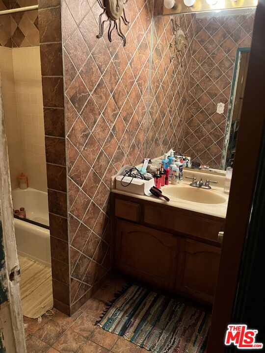 4431 Don Ricardo Drive, Unit 10 Los Angeles, CA 90008 - Photo 7 of 11 a bathroom with a sink and a mirror