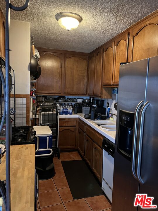 4431 Don Ricardo Drive, Unit 10 Los Angeles, CA 90008 - Photo 10 of 11 a kitchen with a sink appliances and cabinets