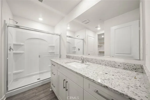 a bathroom with a granite countertop sink mirror and double