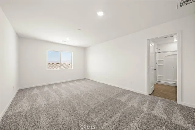 an empty room with a empty space and windows