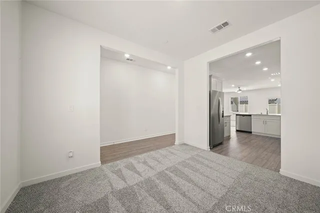 a view of a kitchen with a sink and wooden cabinet