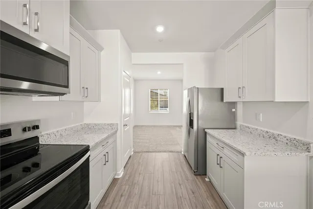 a kitchen with a stove a sink and a refrigerator