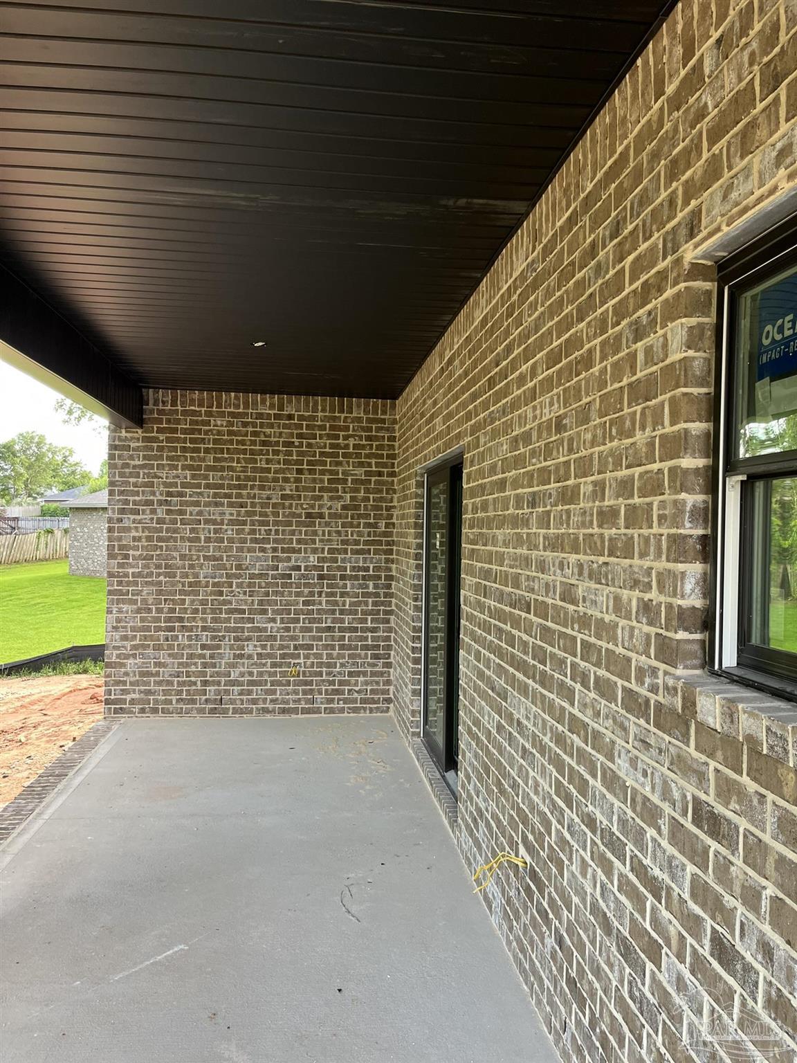 4991 Timber Ridge Drive Milton, FL 32571 - Photo 23 of 25 a view of a porch with a table and chairs next to window