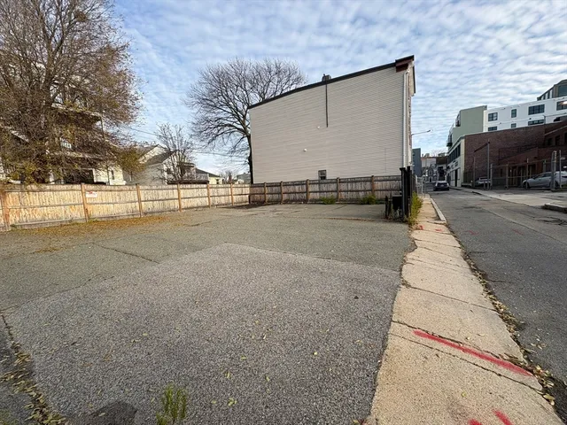 a view of a street with cars parked