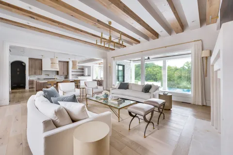 a kitchen with cabinets appliances a sink and a window