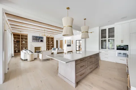 a kitchen with stainless steel appliances a sink stove and cabinets