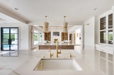 a kitchen with stainless steel appliances granite countertop a sink stove and cabinets
