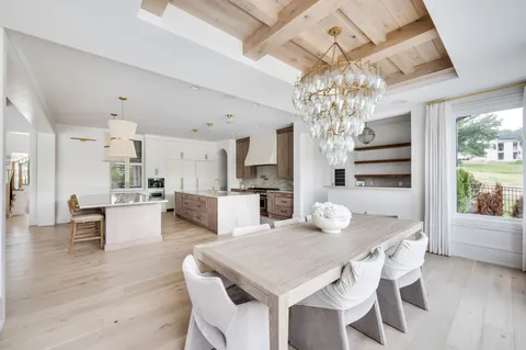 a living room with furniture a large window and flat screen tv
