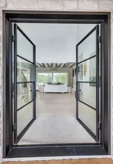 a living room with furniture and a painting on the wall