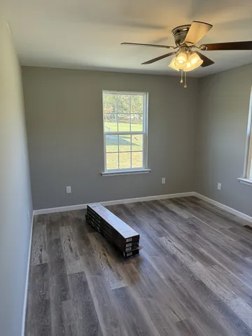 a room with a window and wooden floor