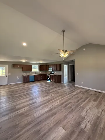 a view of a kitchen with a sink a refrigerator and a window