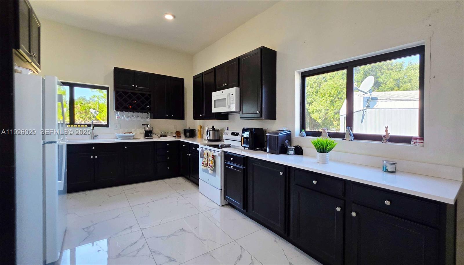 527 Perimeter Road Clewiston, FL 33440 - Photo 12 of 40 a kitchen with a sink cabinets and window