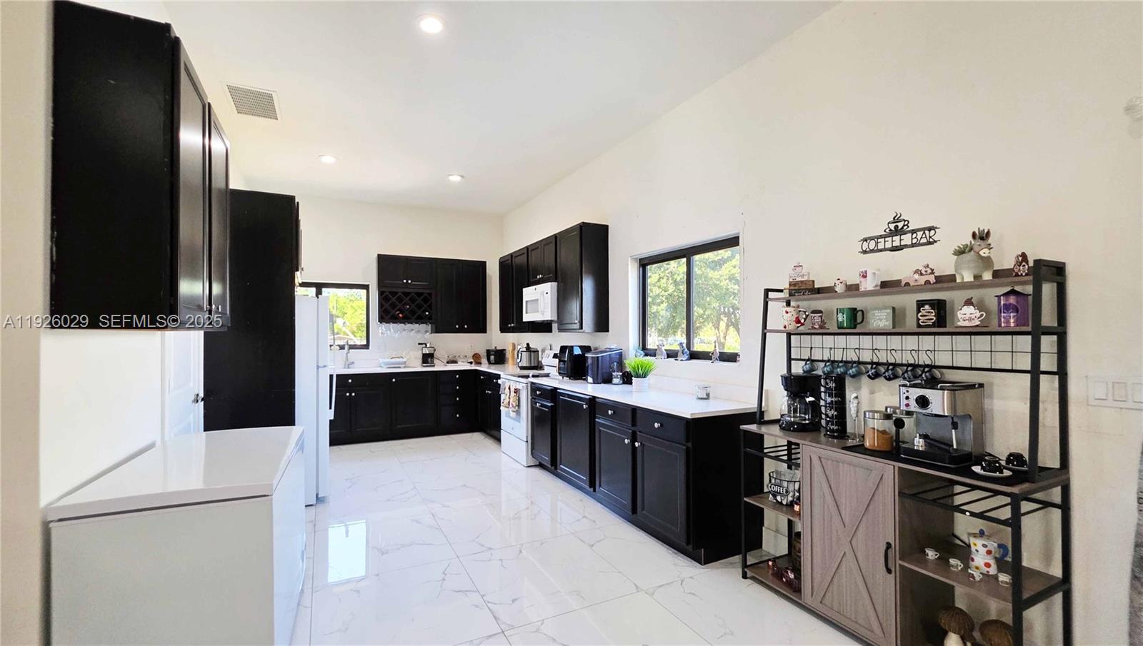 527 Perimeter Road Clewiston, FL 33440 - Photo 17 of 40 a kitchen with kitchen island stainless steel appliances a sink counter top space and cabinets