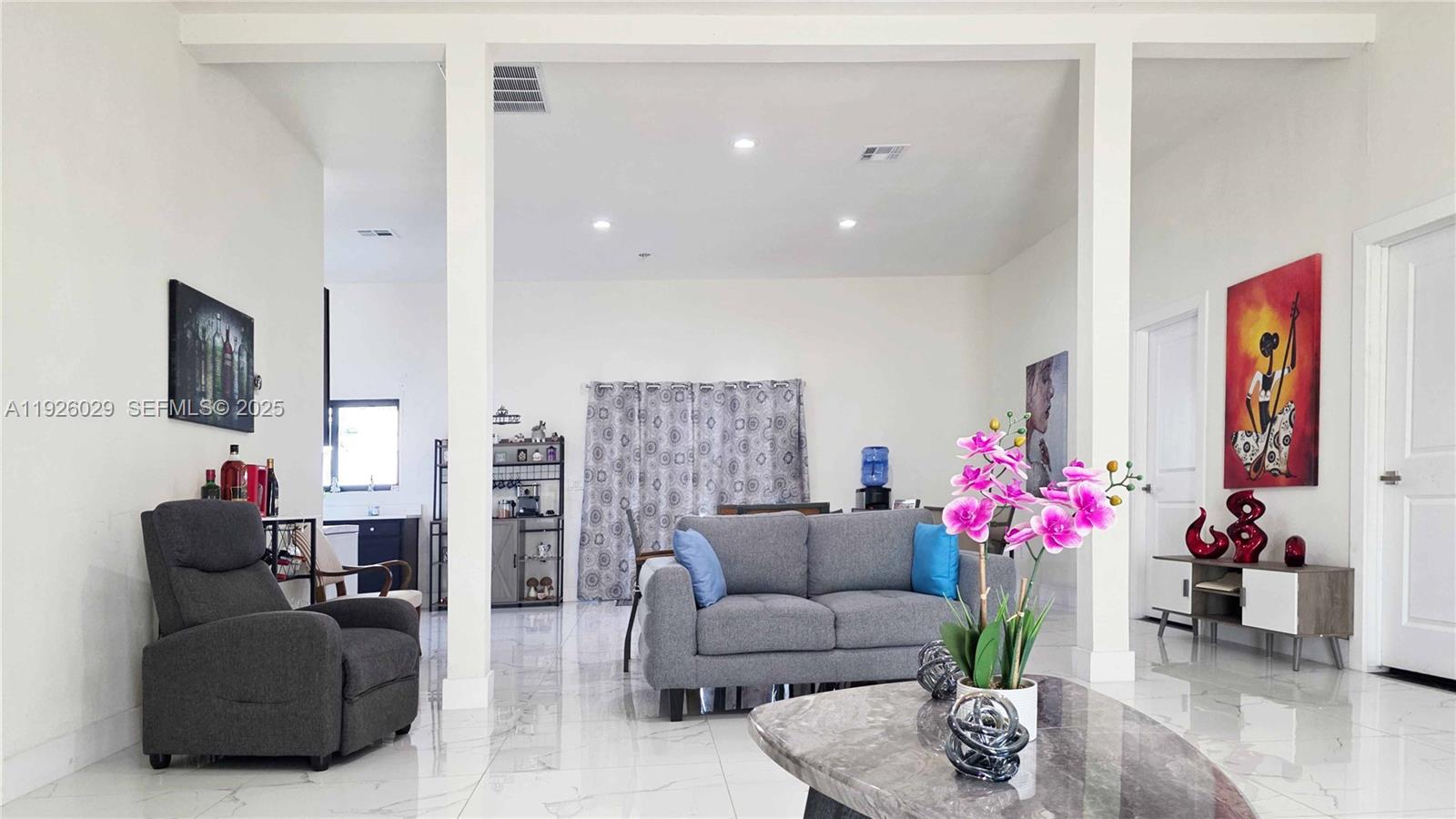 527 Perimeter Road Clewiston, FL 33440 - Photo 20 of 40 a living room with furniture potted plant and a flat screen tv